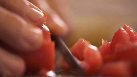 A Cooker Cuting Tomatoes With Two Hands. Stock Footage 258273204