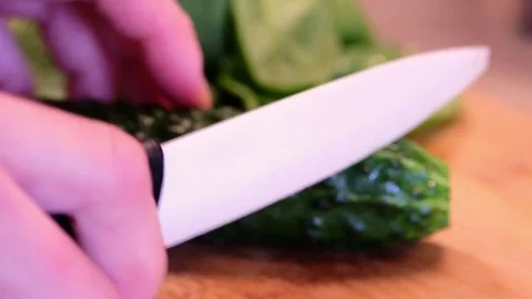 Cooker cutting a cucumber Stock Footage 81950973