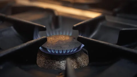 Cooker with gas flame glowing inside a kitchen Stock Footage 266498801