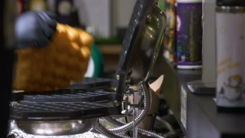 Cooker opens waffle making machine and taking fresh cookie. Stock Footage 164196233