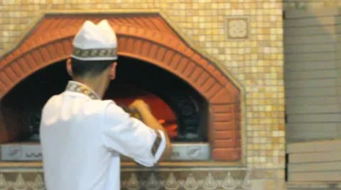 Cooker preparing the oven for pizza Stock Footage 12274308