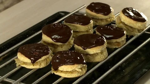 Cooker putting pancakes in oven Stock Footage 119552953