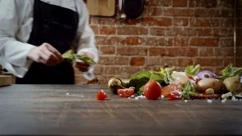 Cookery lessons. A chef preparing products for making a dish in the kitchen. 4K Stock-Footage 78421225