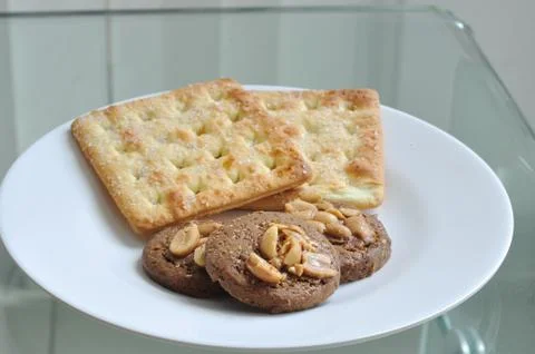 Cookie and bread on white plate Stock Photos