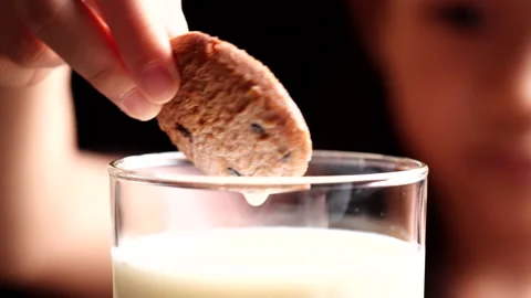 Cookie and Milk, Biscuit. Child girl dipping chocolate chip cookie in milk Vídeo Stock 226506281