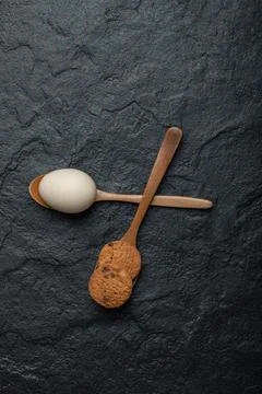 Cookie and raw egg on dark background Stock Photos