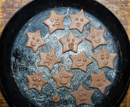 Cookie baking with star-shaped faces in a rustic kitchen setting Stock Photos