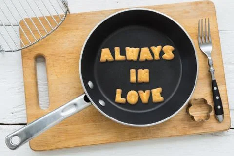 Cookie biscuits quote ALWAYS IN LOVE in frying pan Stock Photos