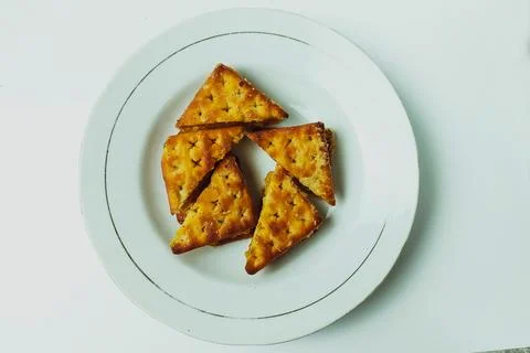Cookie biscuits on a white plate on a plain white table Stock Photos