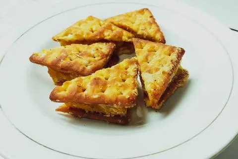 Cookie biscuits on a white plate on a plain white table Stock Photos