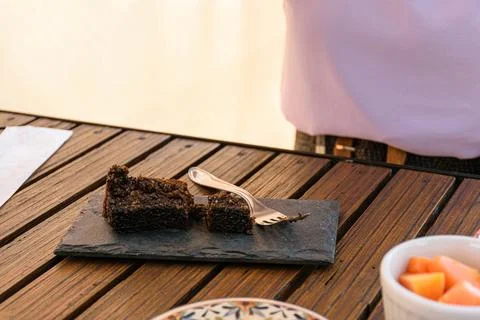 Cookie cake on a slate stone next to a fork. Stock Photos