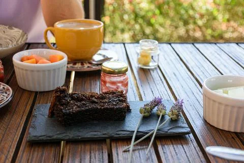 Cookie cake on a slate stone, next to lavender flowers and a small empty jar  Stock Photos
