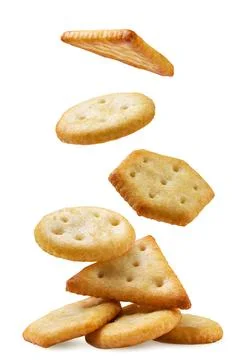 Cookie crackers fall on a pile close-up on a white. Isolated Stock Photos
