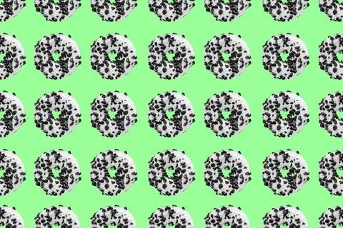 Cookie donut pattern on green background Pattern made with black and white... Stock Photos