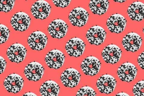 Cookie donut pattern on red background Pattern made with black and white c... Stockfoto's