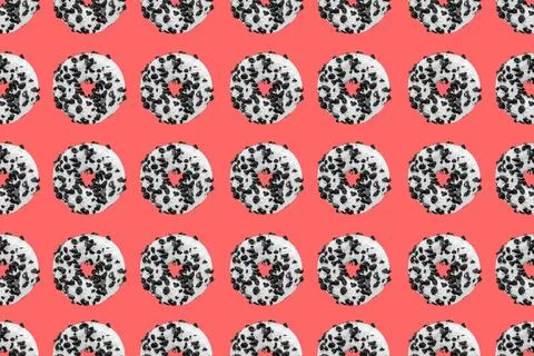Cookie donut pattern on red background Pattern made with black and white c... Stock Photos