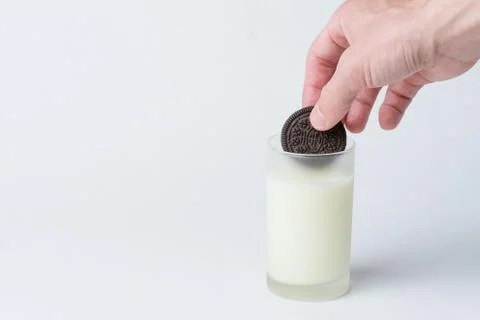 Cookie Dunked in Milk Stock Photos