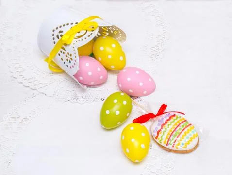 Cookie Easter eggs and eggs in peas poured from a pot . Stock Photos