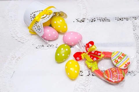 Cookie Easter eggs and eggs in peas poured from a pot . Stock Photos