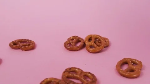 The cookie falls on the table. Pink background. Stock Footage 126588917