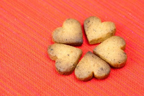 Cookie  in the form of heart  in a plate  on a red background Stock Photos