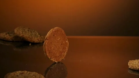 Cookie rolling on a dark reflective surface Stock Footage 327052184