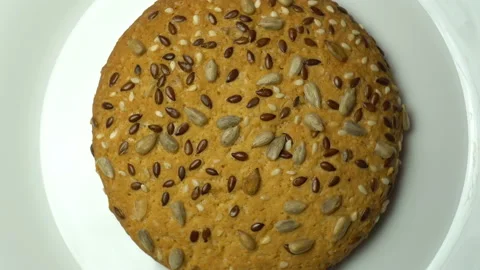 Cookie rotating on white plate. Camera zooming in. Top view Stock Footage 85992531