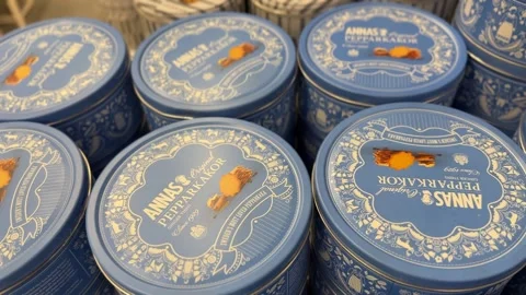Cookie tins with decorative blue design stacked on a shelf in a grocery sto.. Stock Footage 324707574