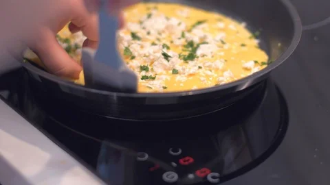 Cookie turns the omelette into a roll Stock Footage 106472335