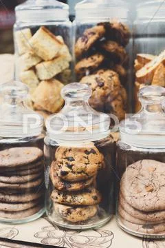 Cookies and biscuits in glass jars on bar for sale Stock Photos