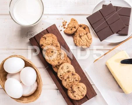 Cookies and their ingredients on a white wooden table Stock Photos