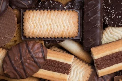 Cookies assorted on black background. Delicious morning snacks for breakfast Stock Photos