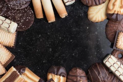 Cookies assorted on black background. Delicious morning snacks for breakfast Stock Photos