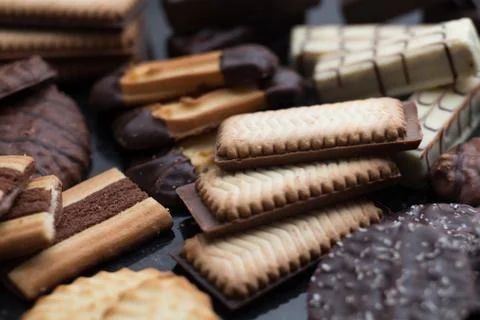 Cookies assorted on black background. Delicious morning snacks for breakfast Stock Photos