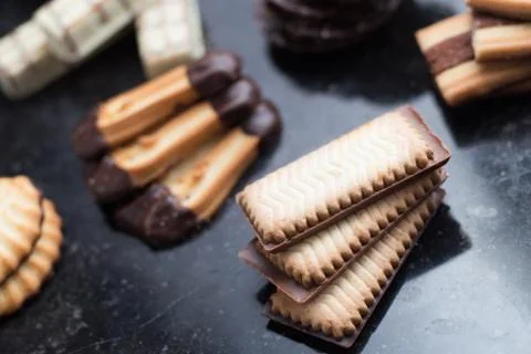 Cookies assorted on black background. Delicious morning snacks for breakfast Stock Photos