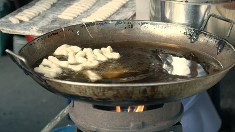 Cookies in boiling oil Stock Footage 108575762