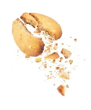 Cookies broken into two halves with falling crumbs down Stock Photos