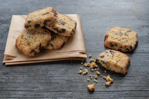 Cookies with dark chocolate chips on rustic background Stock Photos