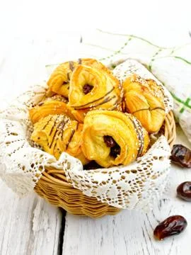Cookies with dates in basket on light board Stock Photos