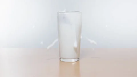 Cookies fall into milk Stock Footage 231552417