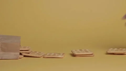 Cookies fall out of the craft package on a yellow background. Stock Footage 169153290