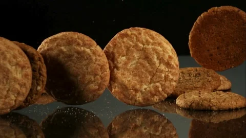Cookies falling and stacking on black surface Stock Footage 327051412
