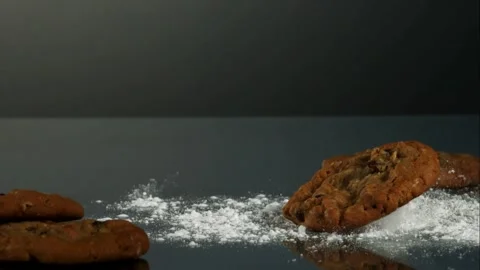 Cookies falling onto table with powdered sugar Stock Footage 327051766
