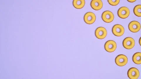 Cookies pattern with copy space on bright purple background. Creative sweet f Stock Photos