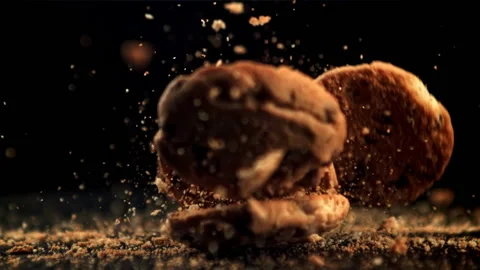 Cookies with pieces of chocolate fall on the table and crumble. Filmed is slow Stock Footage 171149285