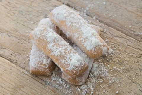 Cookies of rectangular shape in powdered sugar on wooden background, homemade Stock Photos