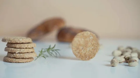 Cookies rolling around on the table before falling. Slow motion. Stock Footage 106141164