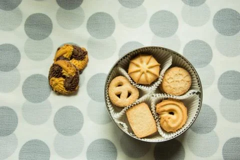 Cookies with sugar in a round box on a tablecloth with polka dots Stock Photos