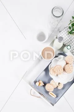 Cookies On White And Gray Plate With Cups Of Coffee And Bottles Of Milk On Wh