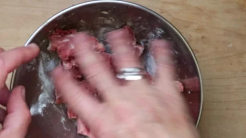 Cooking: Adding and mixing flour to stewing steak Video stock 278348219